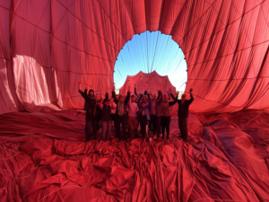The team inside the red hot air balloon as it deflates
