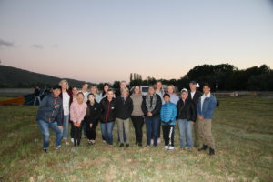 Dr Stephen Lising and past and present team members gather at dawn